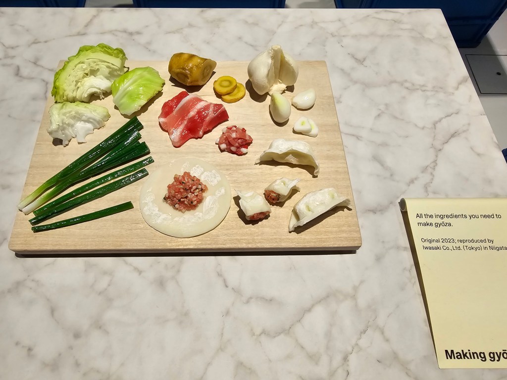 Food replicas: a wooden board with ingredients for making gyoza dumplings.