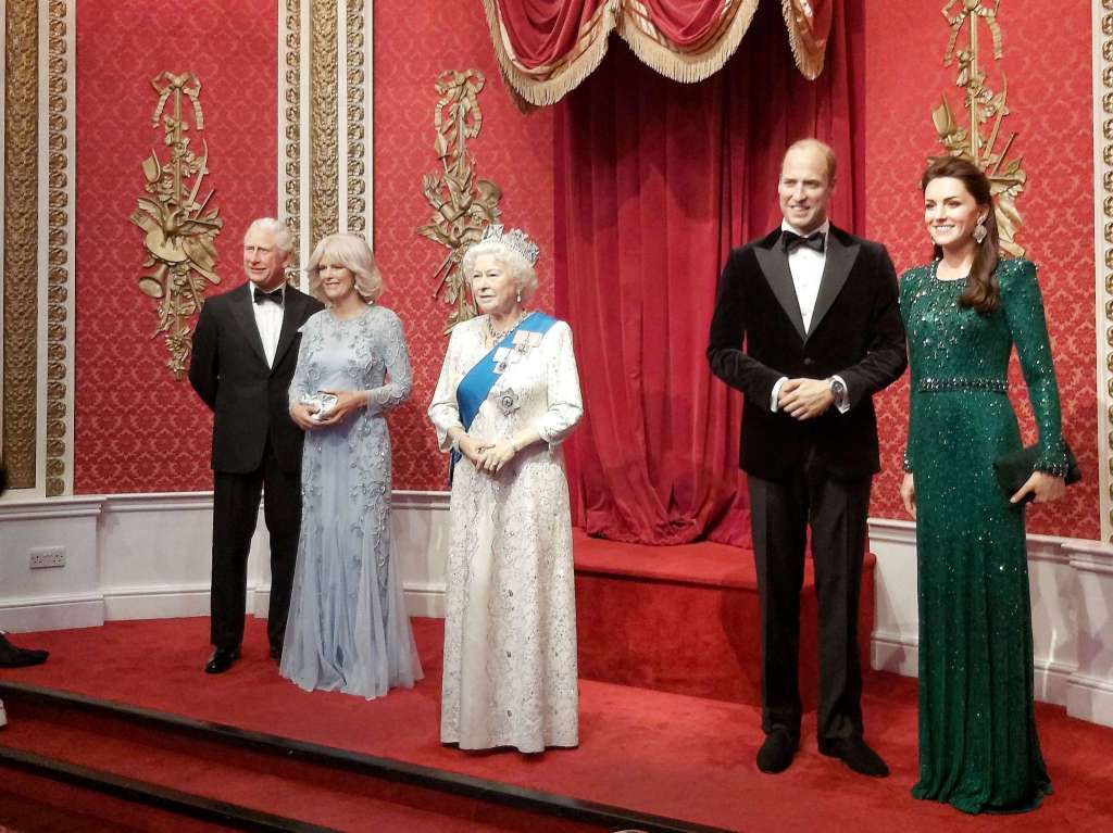Wax figures of the British Royal Family in Madame Tussauds museum in London: Queen Elizabeth II, Prince Charles with Camilla, Prince William with Kate.