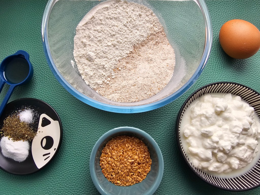 Ingredients for protein cottage cheese bread rolls: flour, cottage cheese, egg, golden linseed, bicarbonate of soda, mixed herbs, salt and avocado oil.