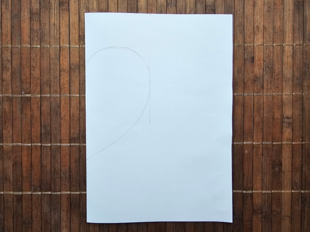 How to make a heart shaped template - half of a heart is drawn on a folded piece of paper.