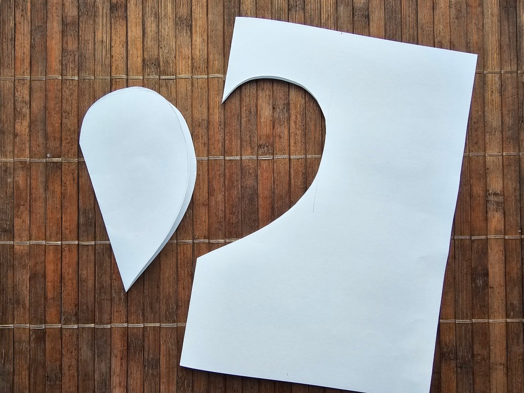 How to make a heart shaped template - half of a heart is cut out of folded paper.