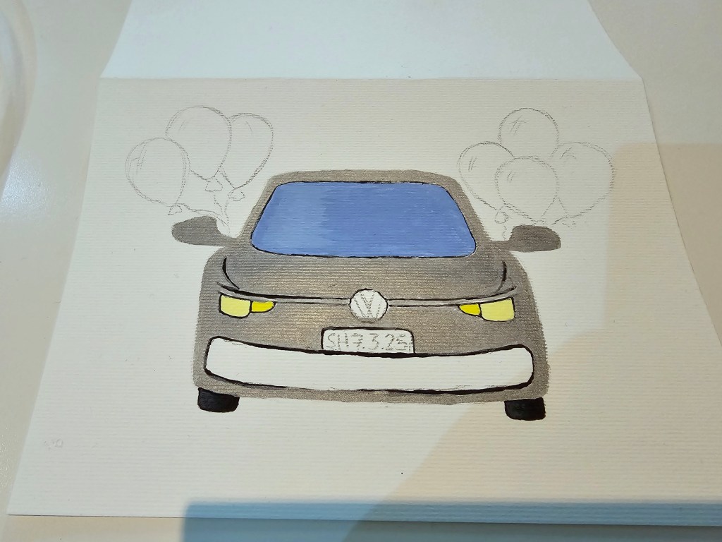 A silver Volkswagen car with balloons attached to mirrors. A DIY birthday card painted with acrylics. Most of the car is painted, but the balloons are still a pencil sketch.