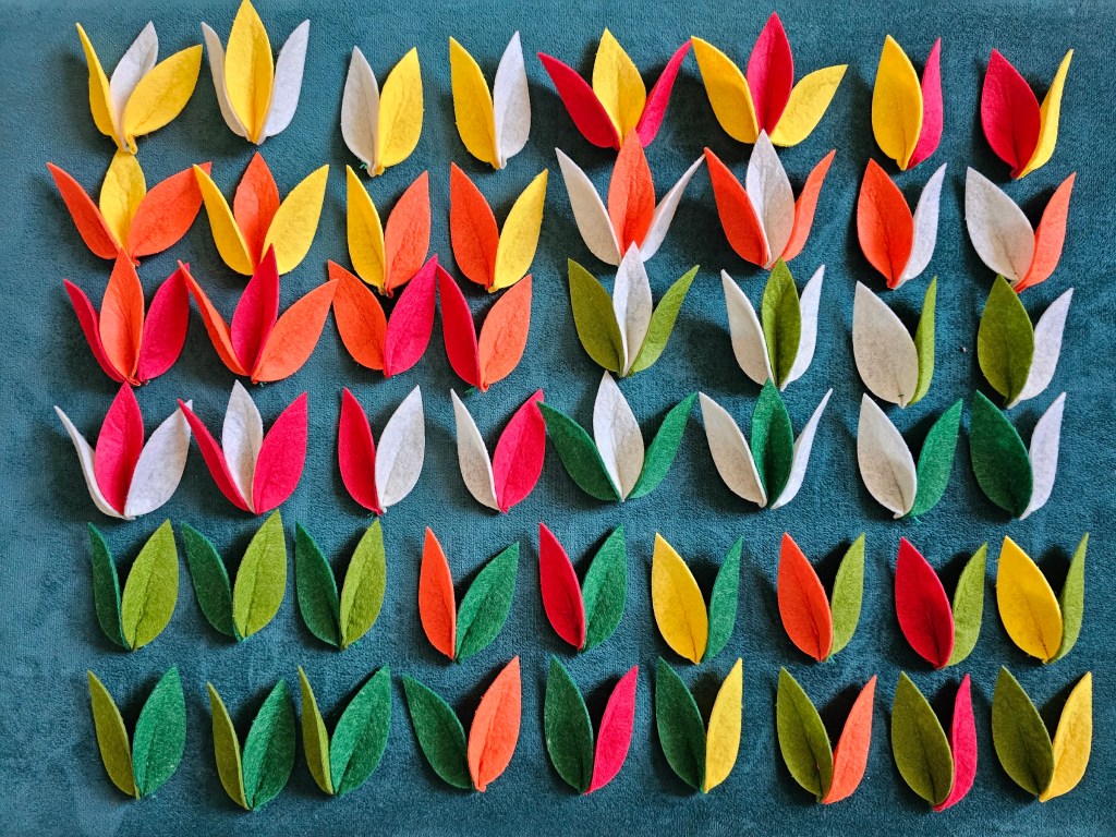Dozens of felt flowers lined up.