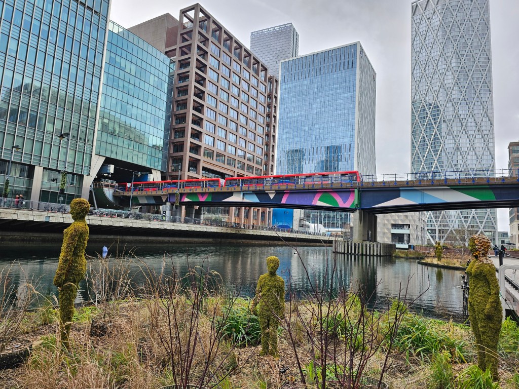 Grass humanoid sculptures in Canary Wharf, London.