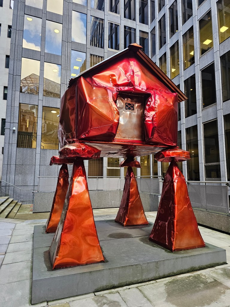 A metal sculpture resembling a witch's hut.