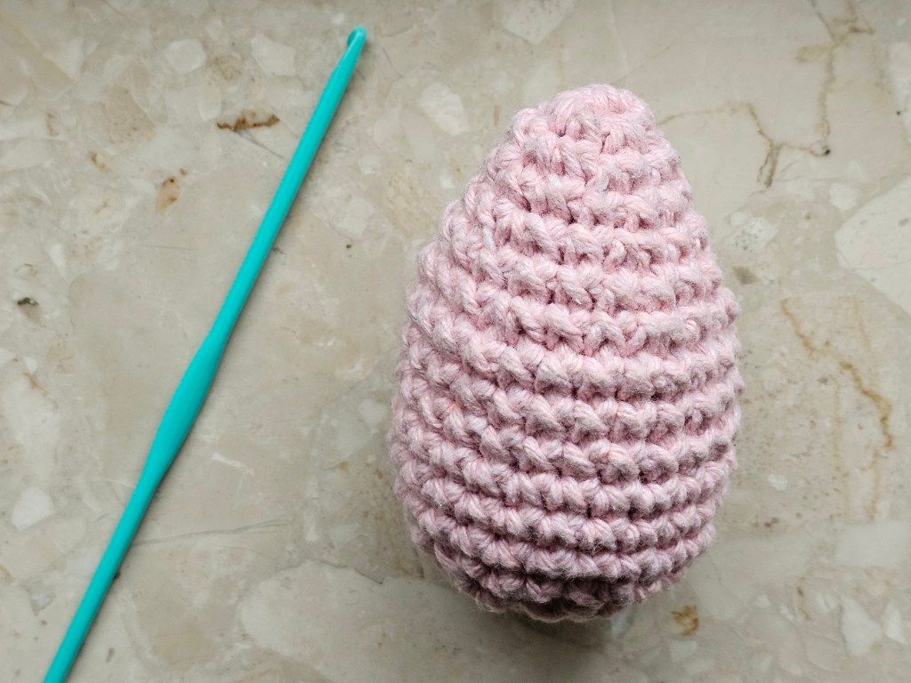 Neat, pink egg made primarily with double stitches.
