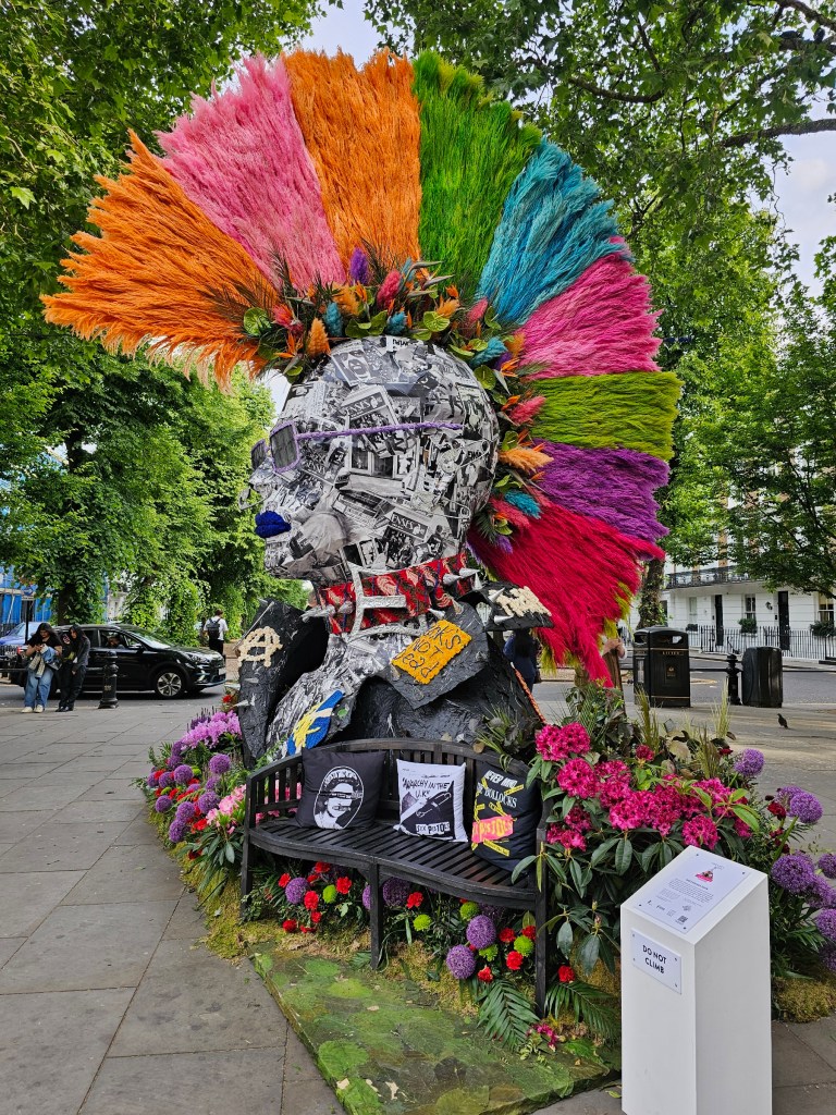 A giant head with colourful mohawk hair - all made of flowers.