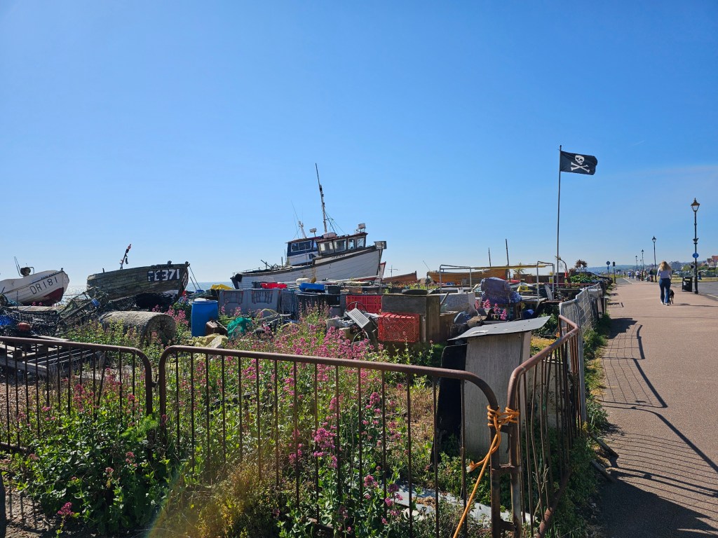 Boats next to the promenade in Deal, England. Pirate flag is waving in the wind.