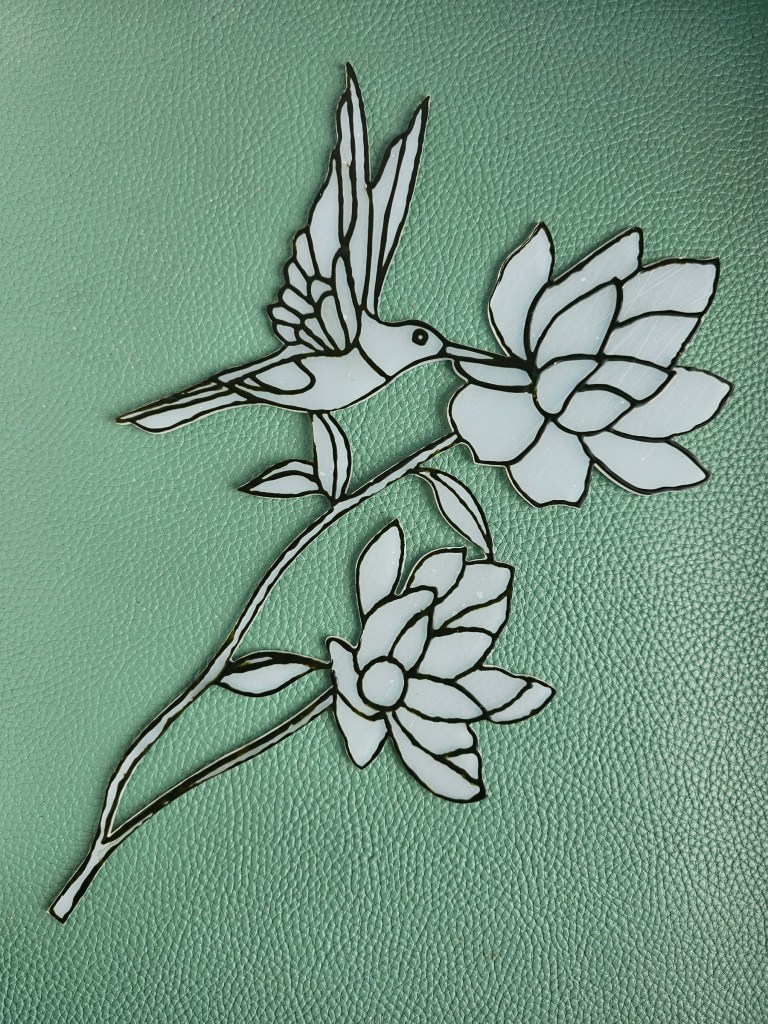 Partially finished fake stained glass ornament. The black outline is done.