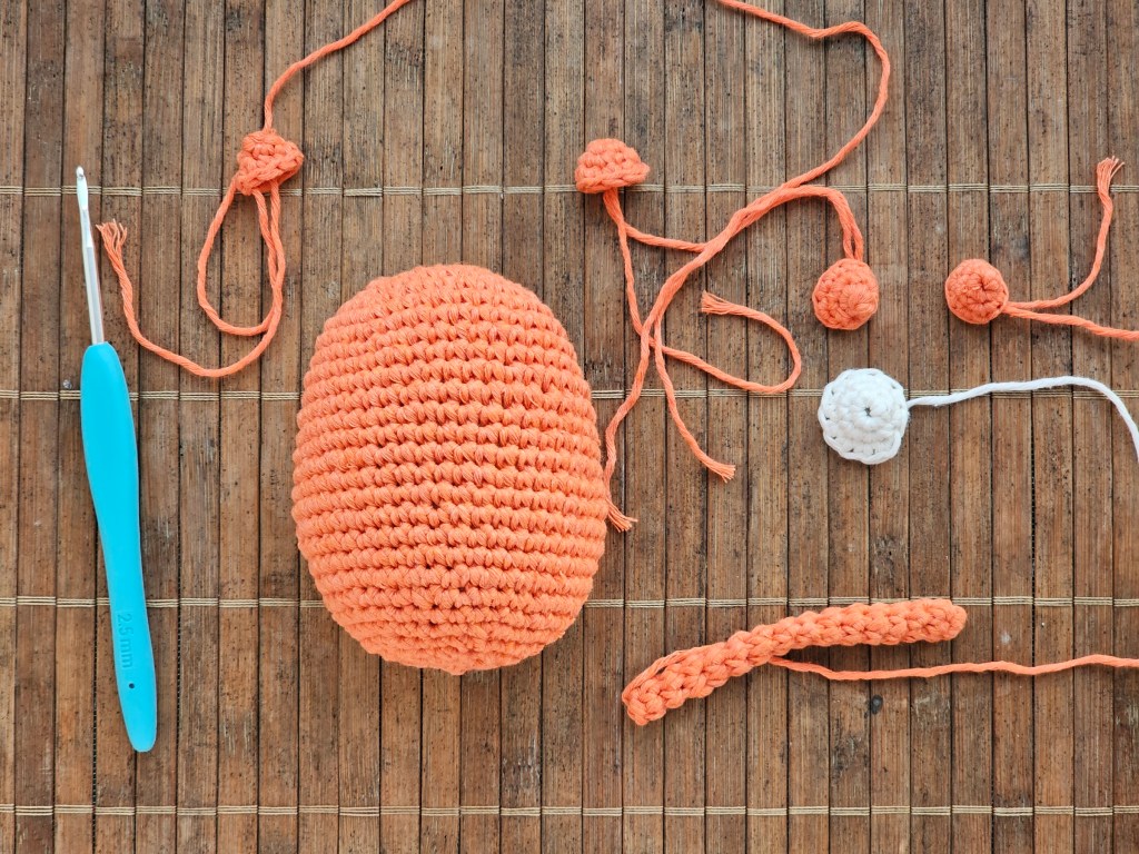 Completed elements for a crocheted tiger plushie, not yet attached.