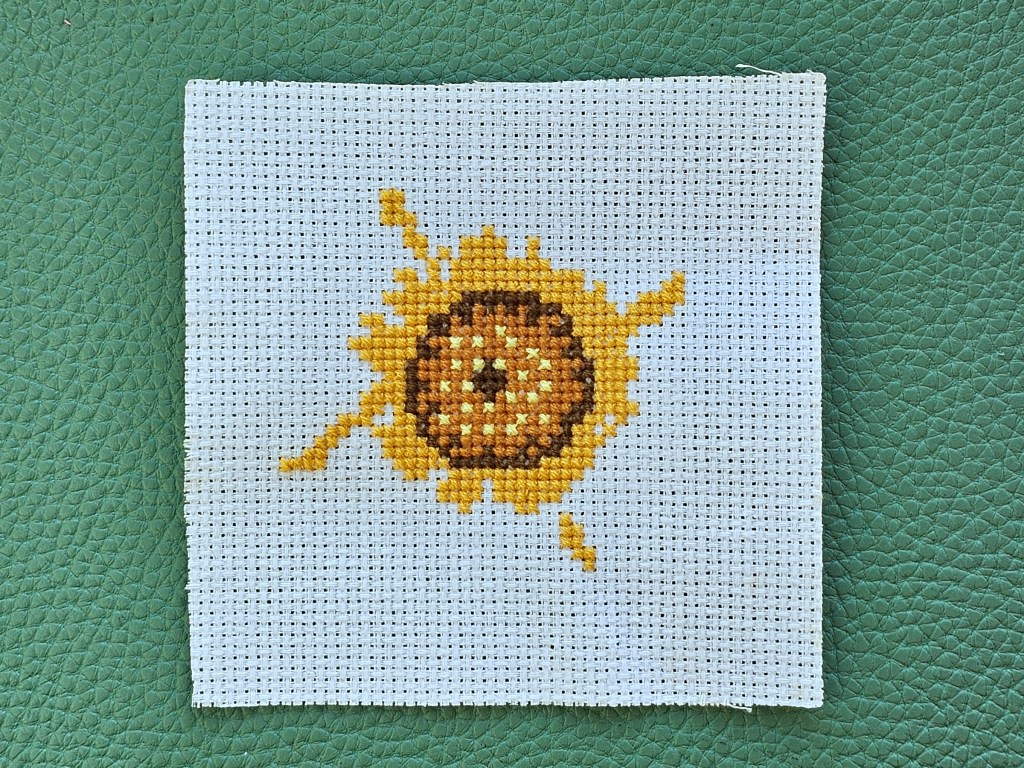 Partly completed cross stitched mini sunflower flower