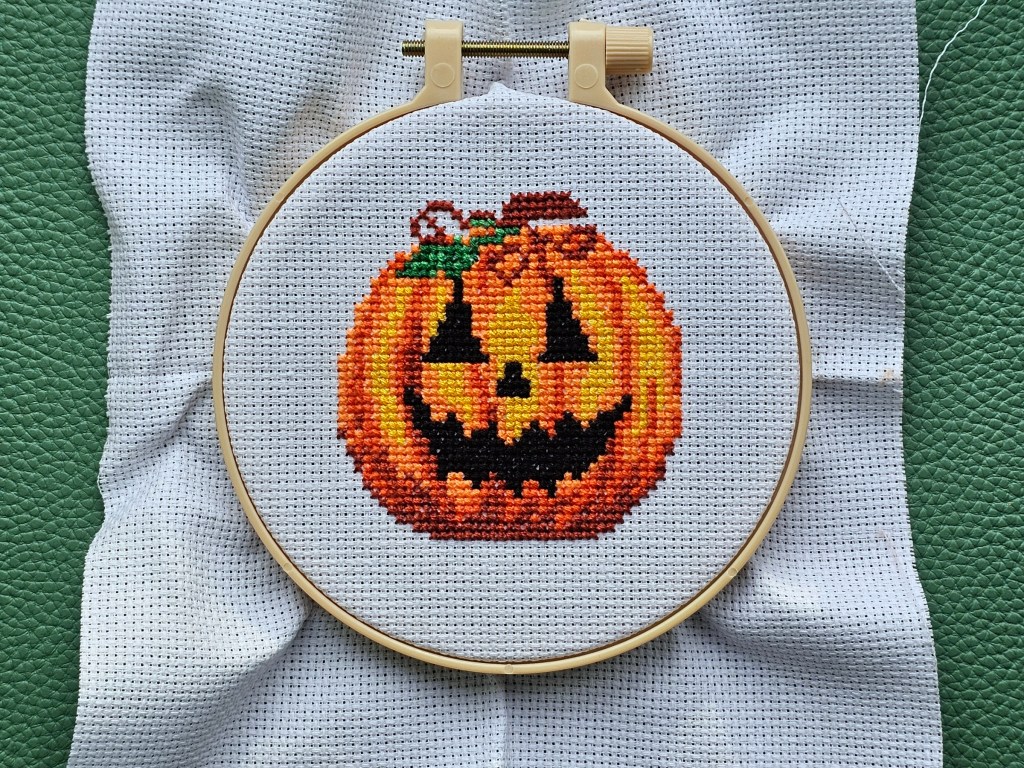 A completed Jack-o'-lantern cross stitch design