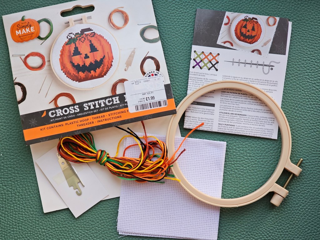 Contents of a cross stitch set for sewing a Jack-o'-lantern