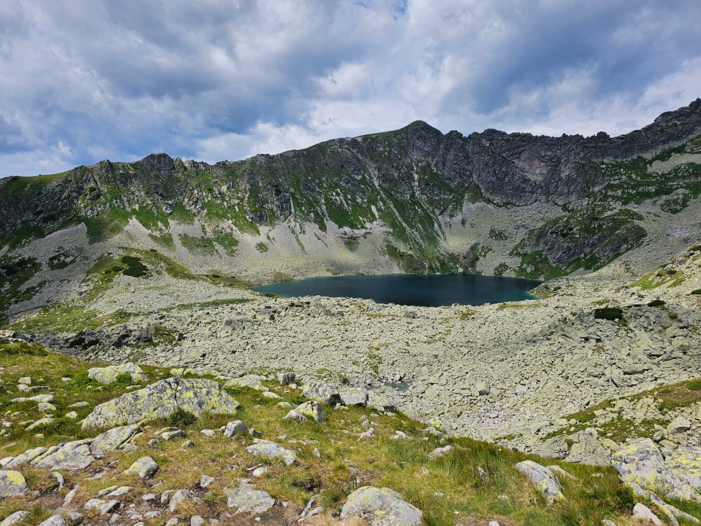 A small lake surrounded by rough mountains