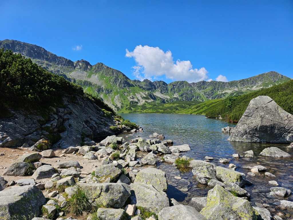 A lake surrounded by mountains in Dolina 5 Stawow