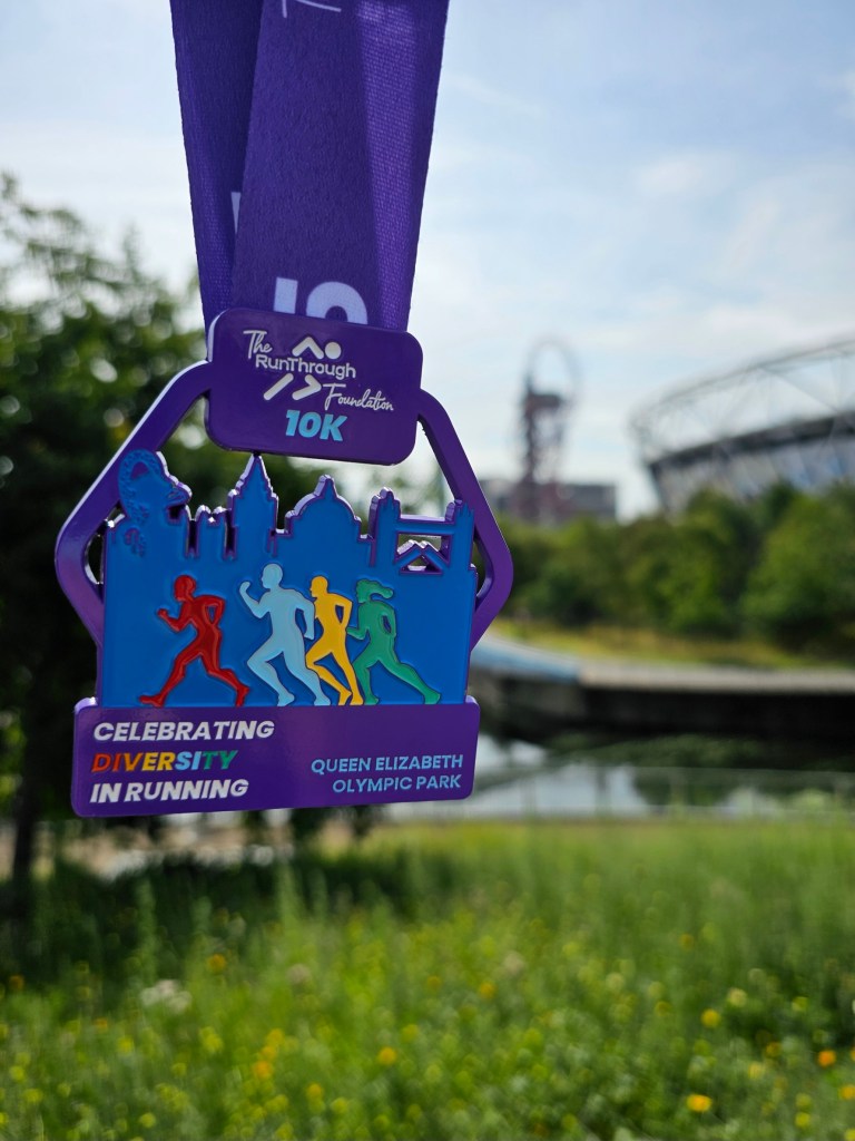 A medal for a 10km run. The Olympic Park in Stratford can be seen in the background.