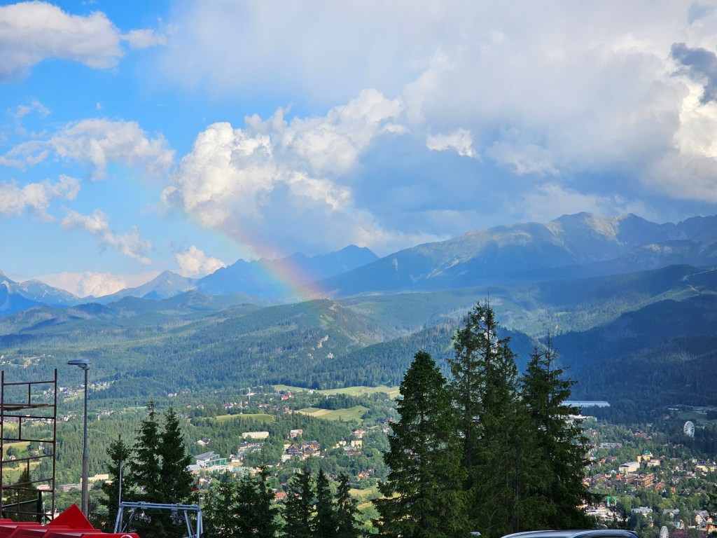 View from Gubalowka hill in Zakopane. A rainbow can be seen in the sky.