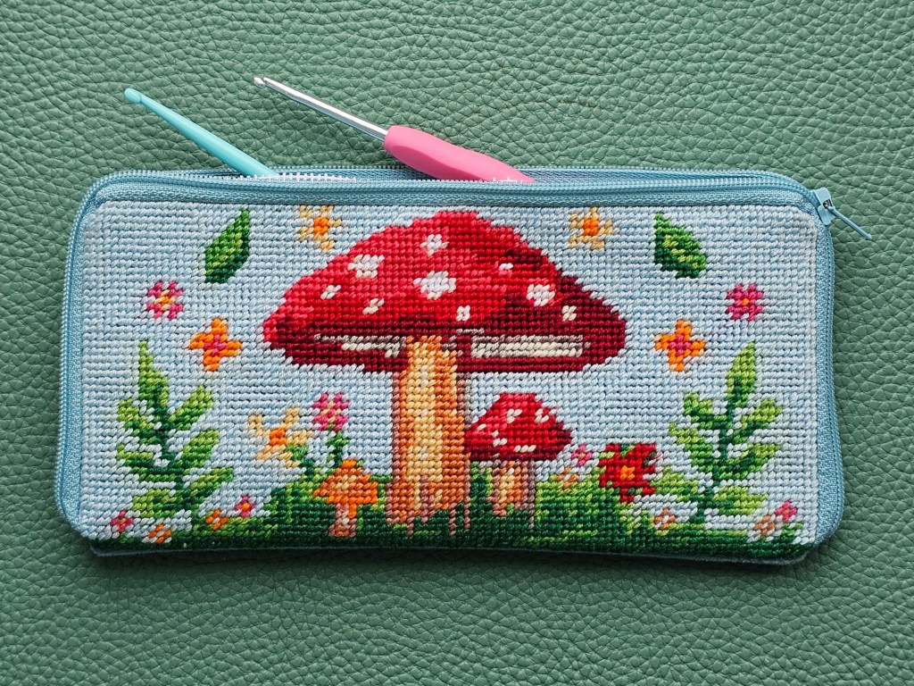 Finished DIY zip case with a half stitch design featuring colourful mushrooms