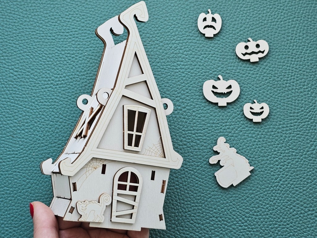 Partially assembled wooden haunted Halloween house.