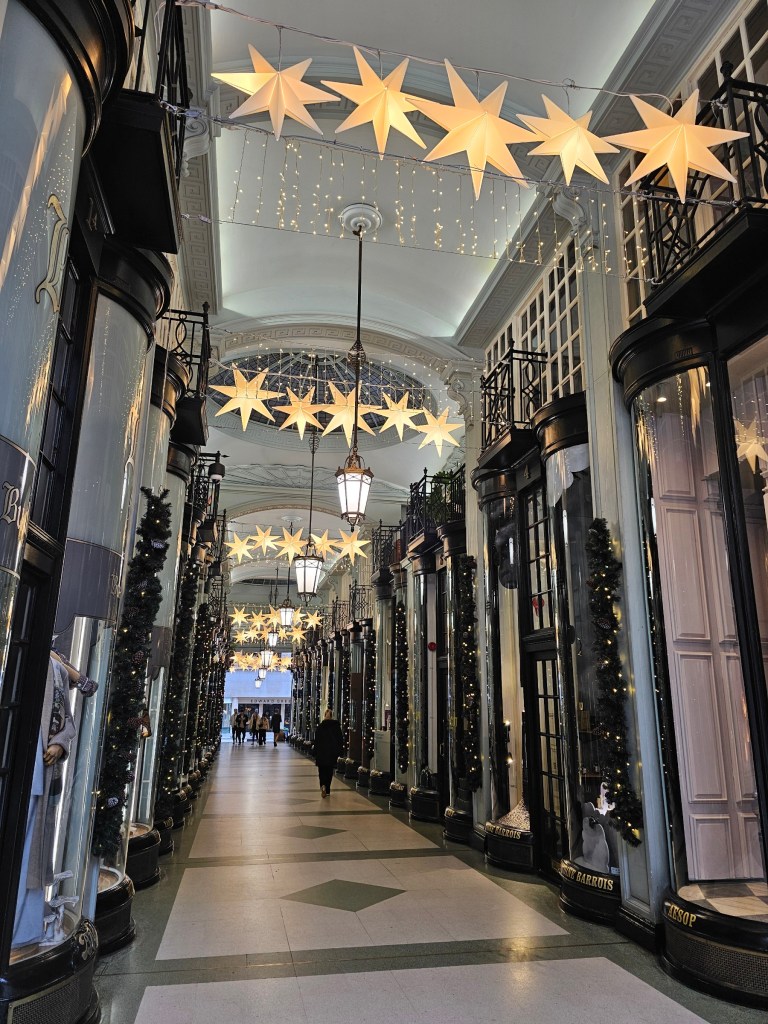An arcade in London with posh shops and star-shaped hanging lights