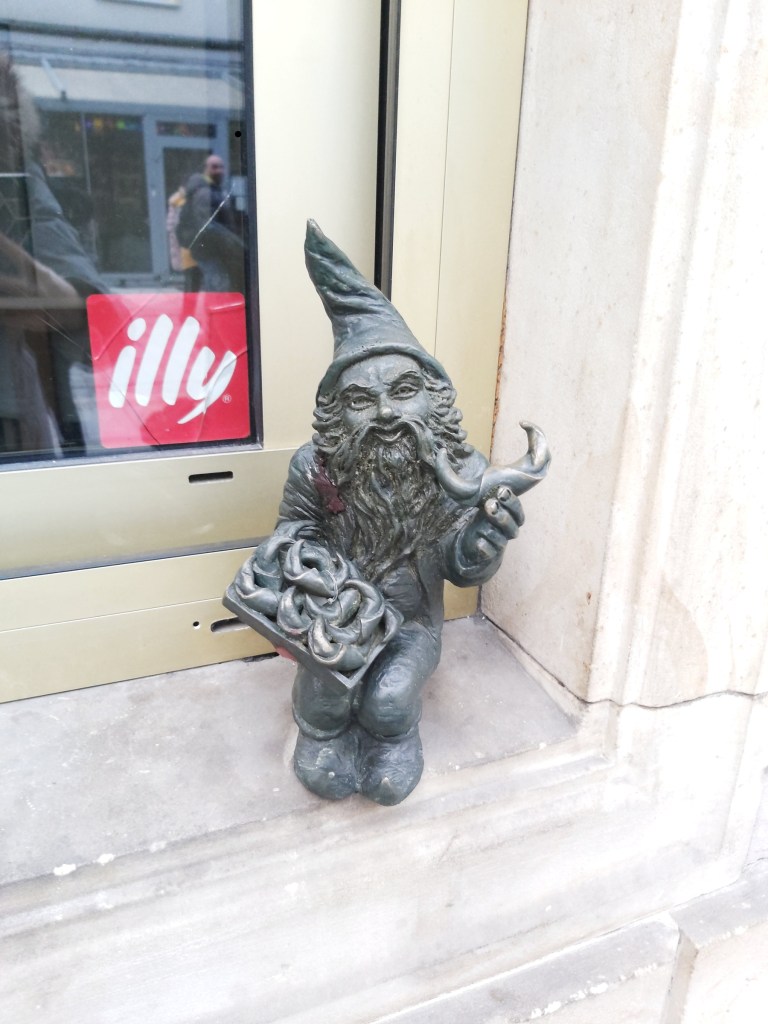 A small metal statue of a dwarf in Wroclaw