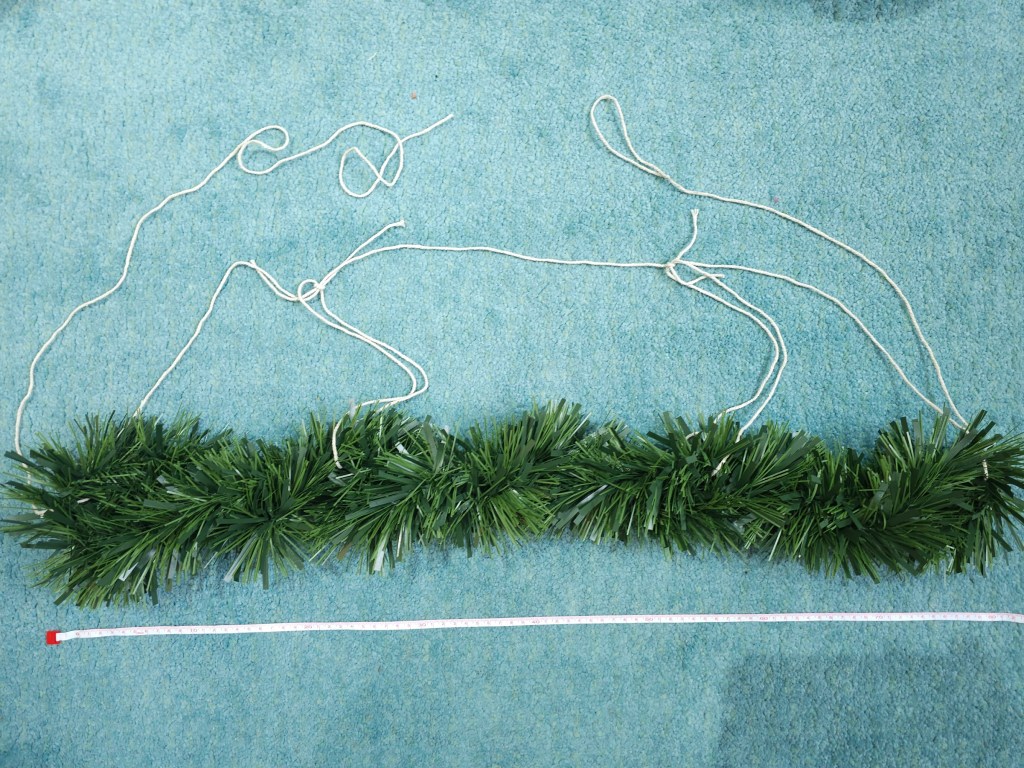 Blank Christmas garland with pieces of string attached.