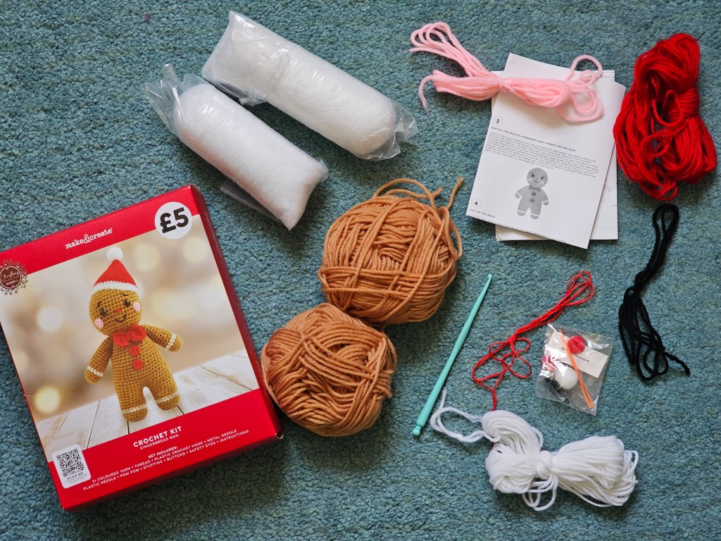 Contents of a DIY kit for crocheting a gingerbread man toy