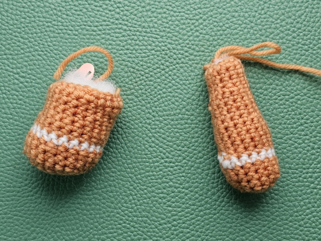 A crocheted leg of a gingerbread man, and a crocheted arm