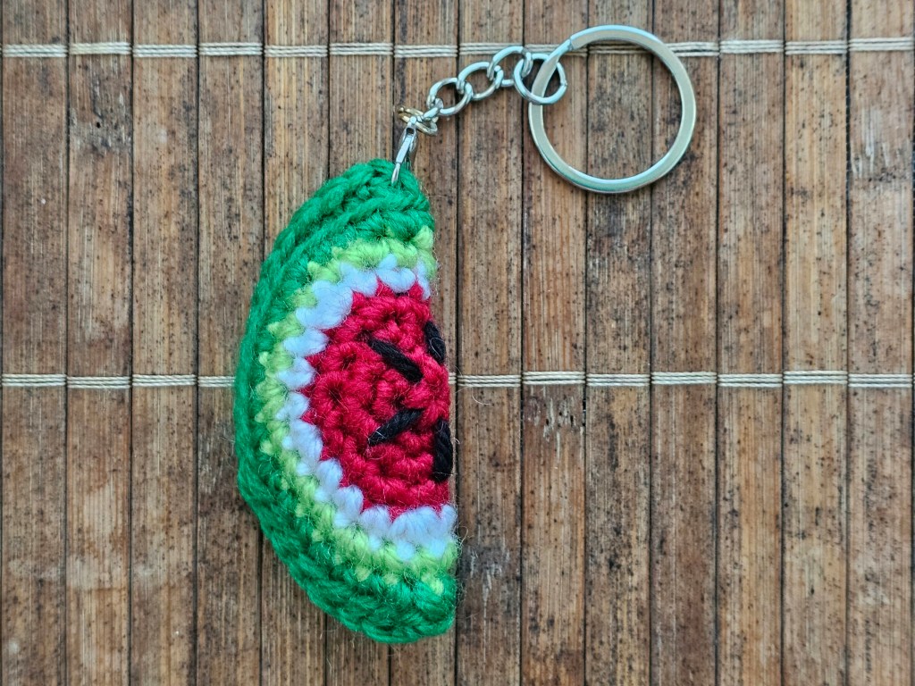 Completed keychain with a tiny crocheted watermelon slice.