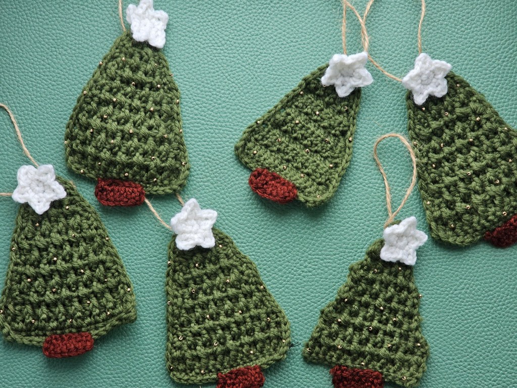 Six crocheted hanging Christmas trees with white stars