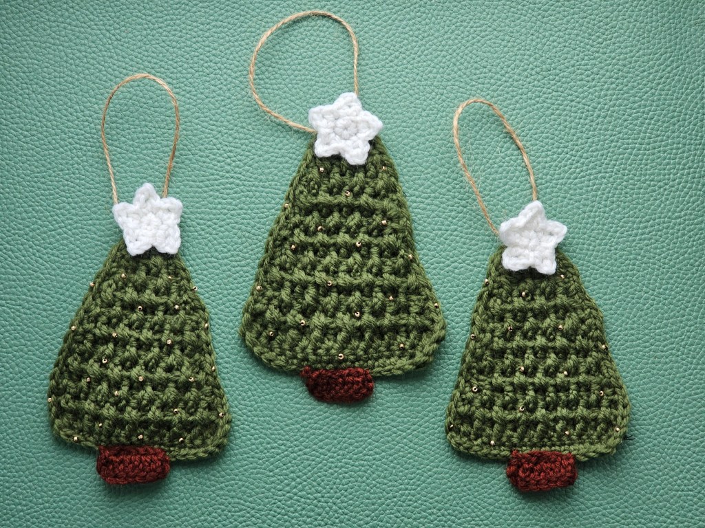Three crocheted hanging Christmas trees with white stars