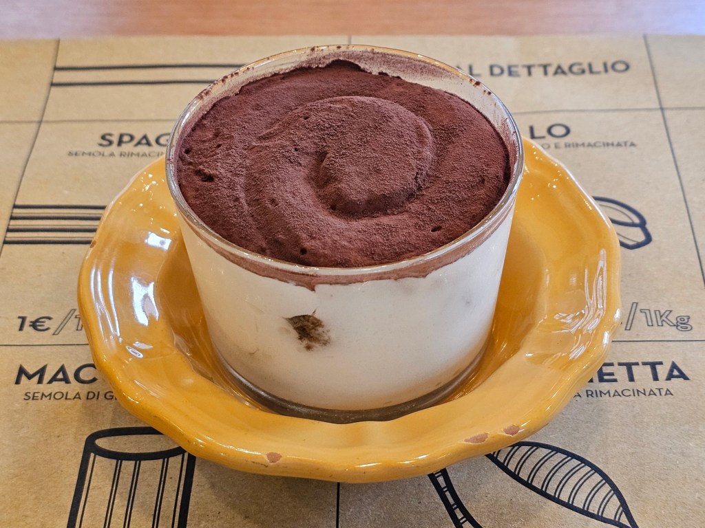 Authentic Italian tiramisu in a glass pot