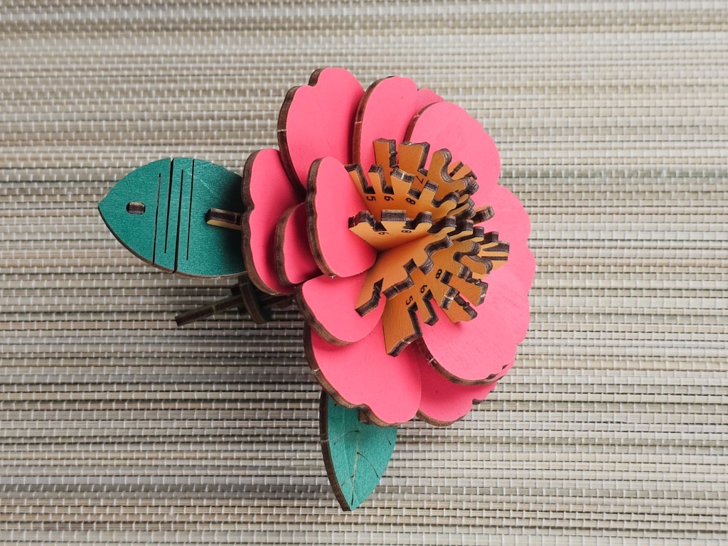 Nearly assembled red 3D wooden flower