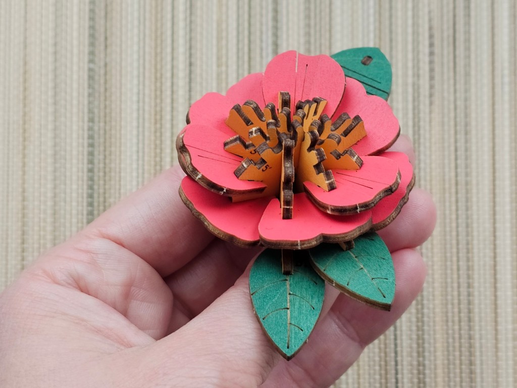 Nearly assembled red 3D wooden flower