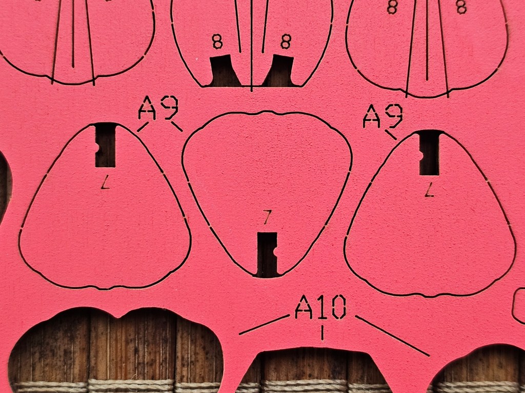 A close up view of wooden flower petals to show a bulge in the slot where two pieces connect