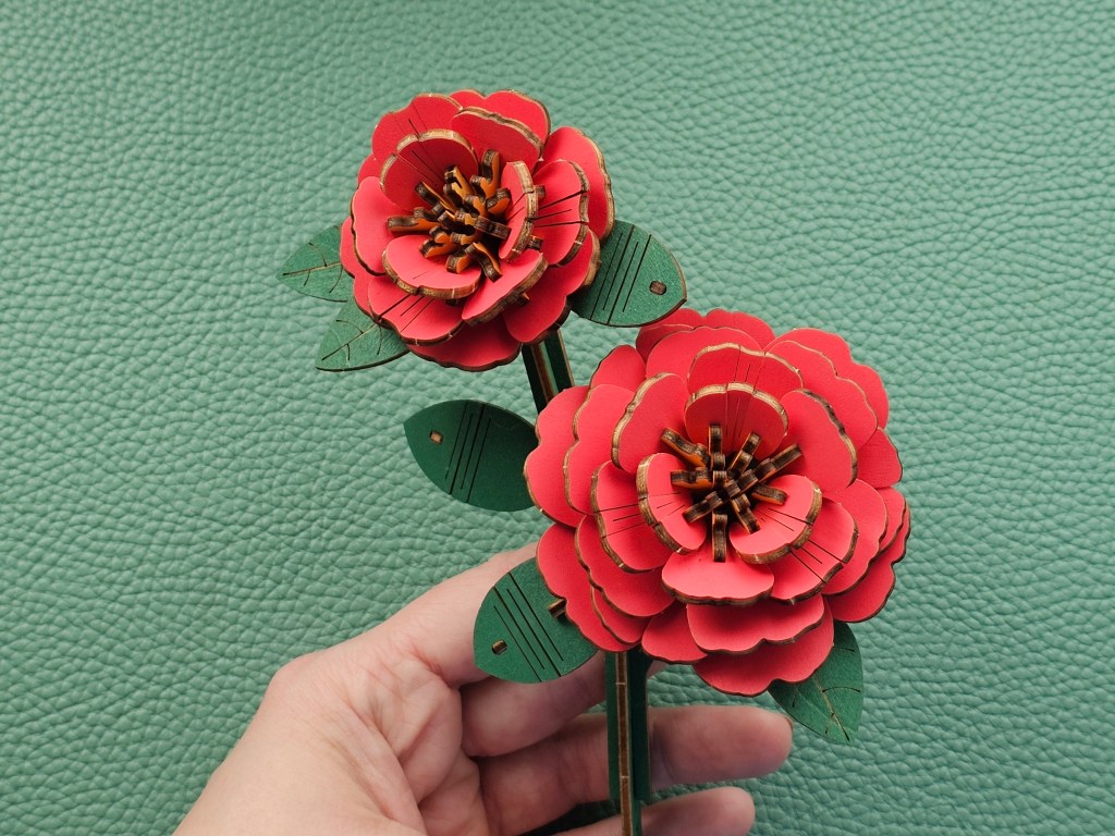 Assembled 3D wooden red flowers on a stem