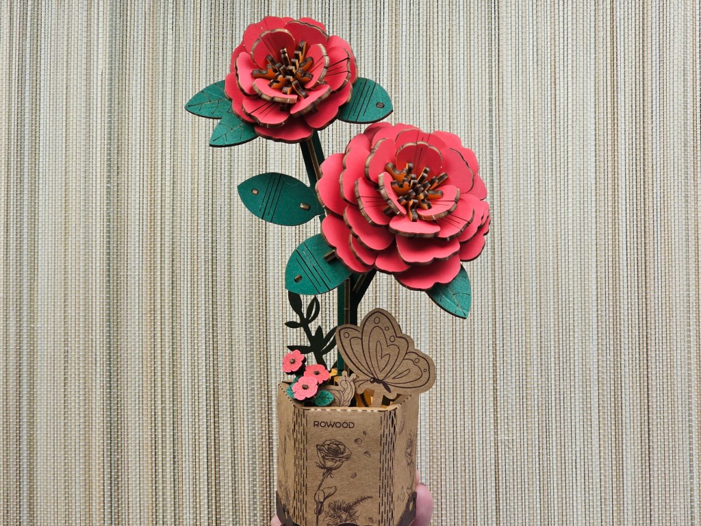 Assembled wooden red flowers in a decorative stand