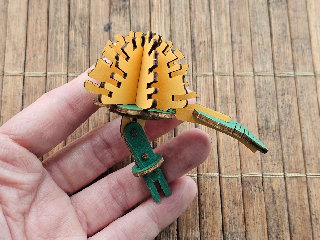 A wooden leaf with a zig zag pattern cut into it to make it pliable