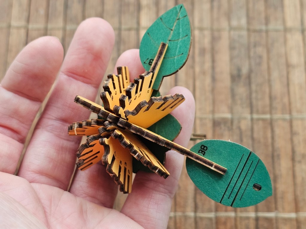 A wooden leaf with a zig zag pattern cut into it to make it pliable