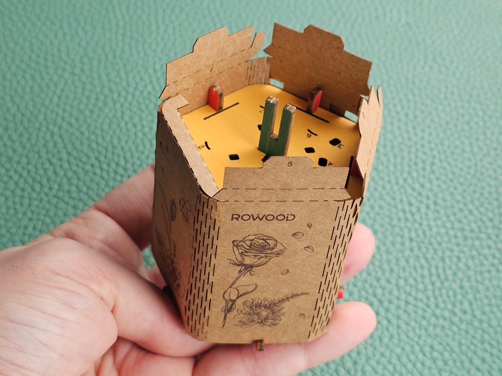 A wooden and cardboard stand for wooden flowers