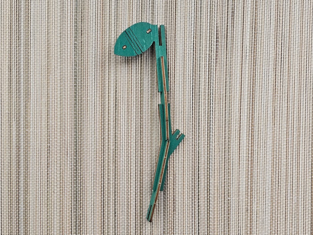 A green wooden stem with a leaf