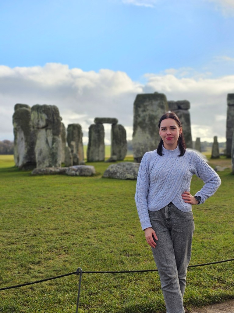 A photo of a person standing in front of the Stone Circle in Stonehenge