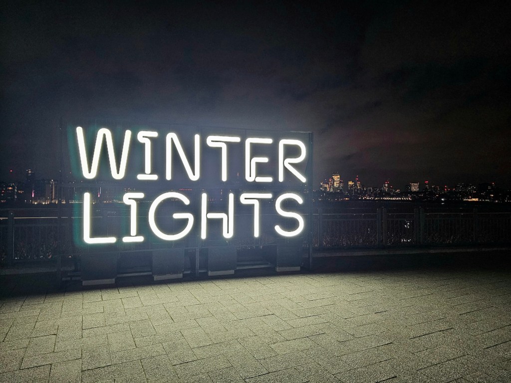 White neon sign spelling 'Winter Lights'. Photo taken at night.