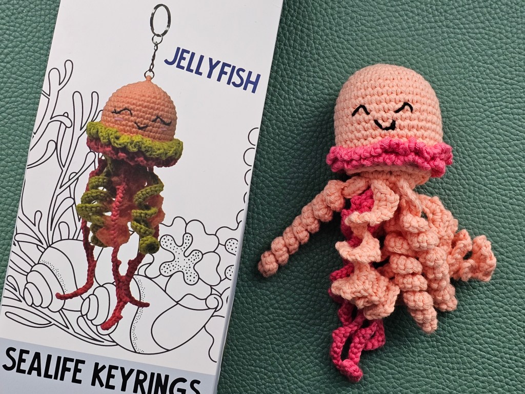 Completed crocheted jellyfish in peach and pink colour