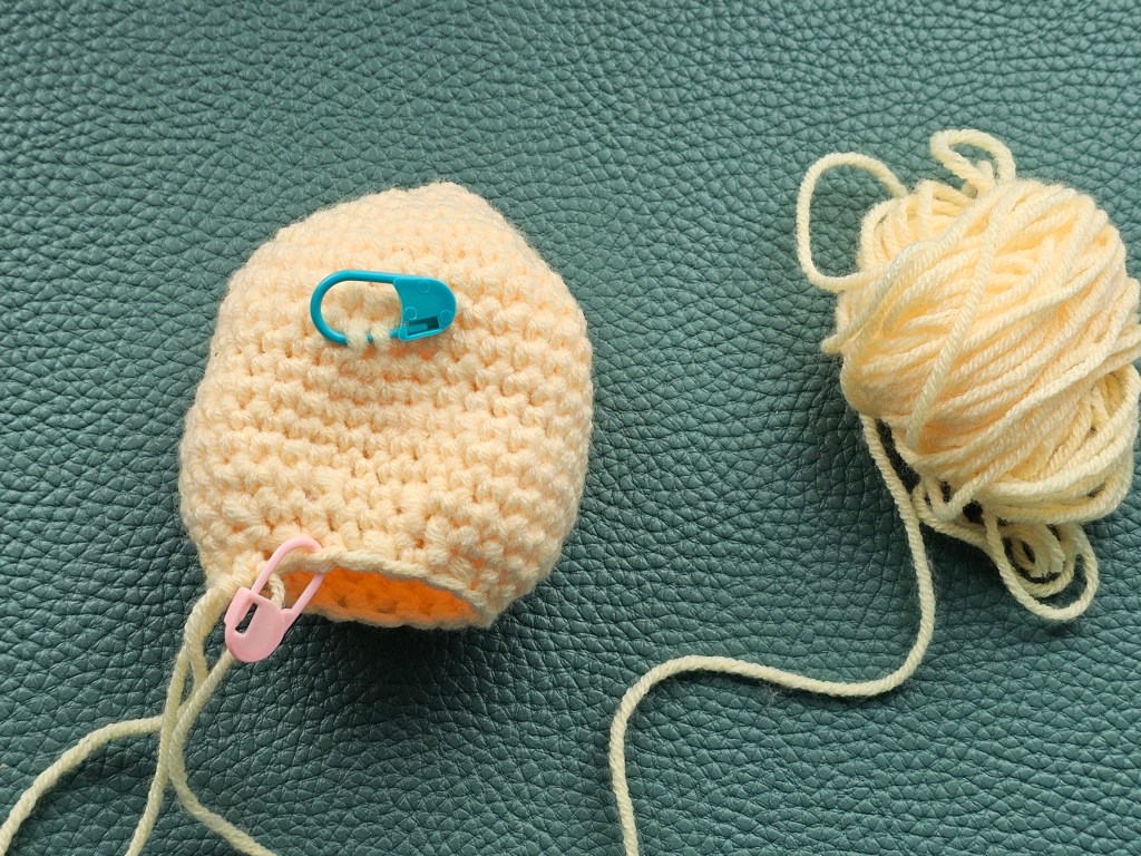 Nearly completed crocheted yellow body of a chicken