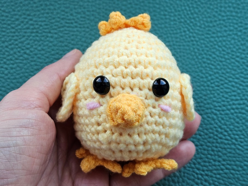 Completed crocheted small yellow chick