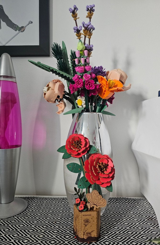Assembled wooden flowers next to a set of LEGO botanicals
