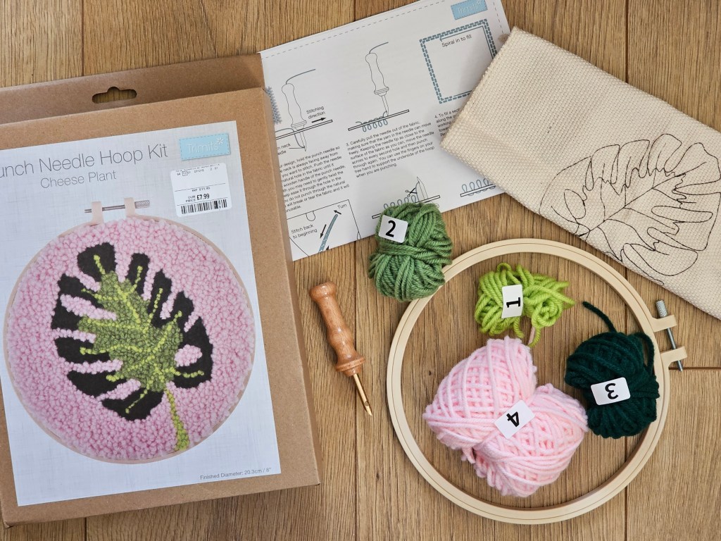 Contents of a punch needle assorted DIY set for making a monstera leaf design