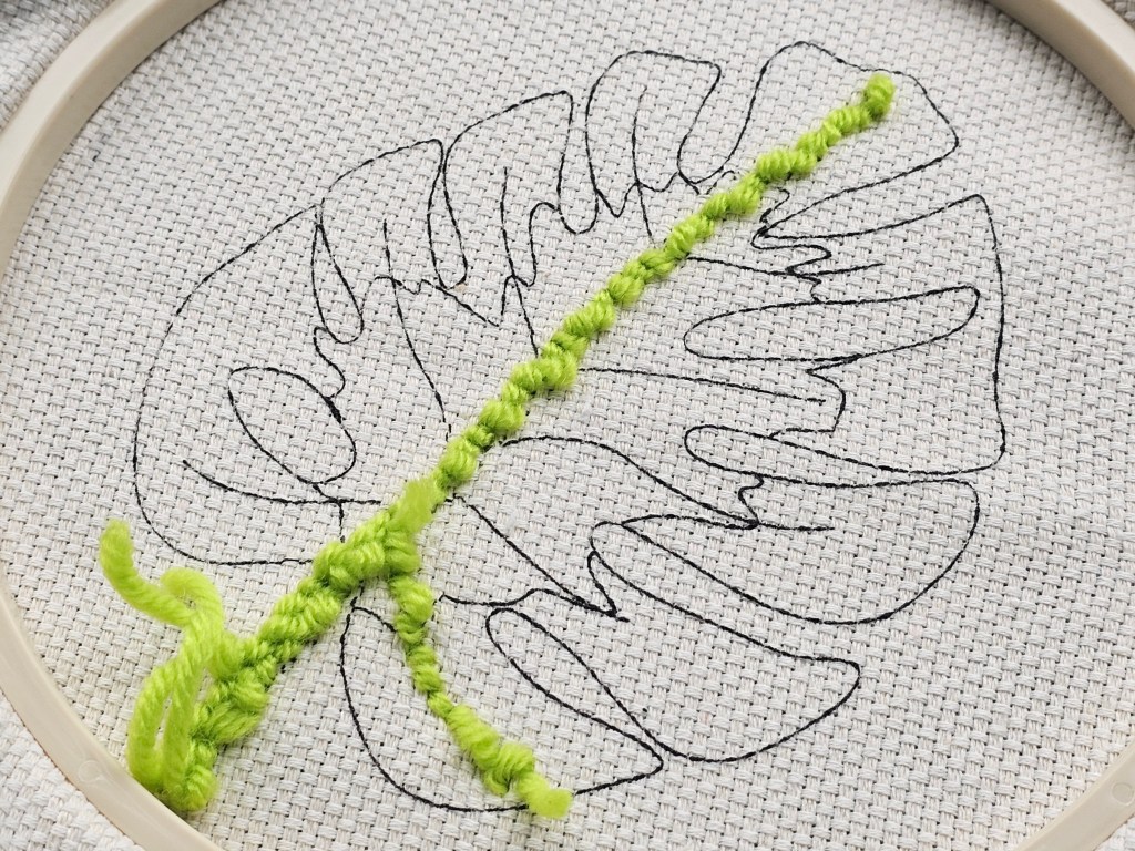 The back side of a punch needle canvas