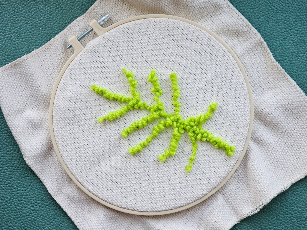 Partially finished punch needle project featuring a monstera leaf